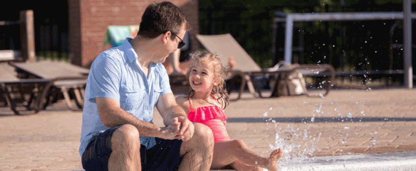 Jeb Shrenk looking at his little girl splashing in rec center pool