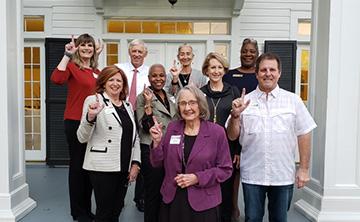 Outstanding employees with Dr. Walrop and wife in front of his house