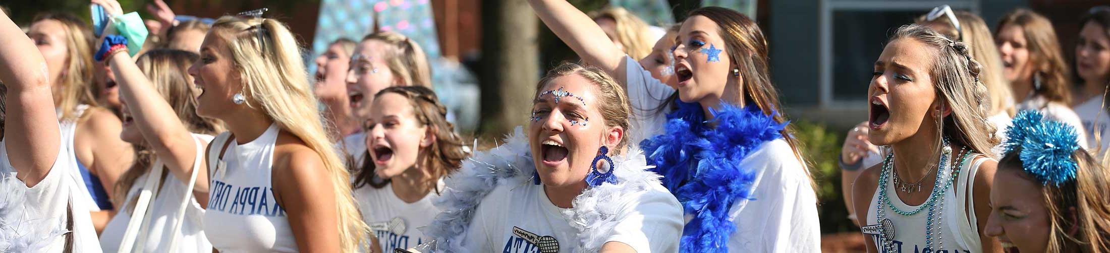 Kappa Delta Bid Day with sorority girls running out.